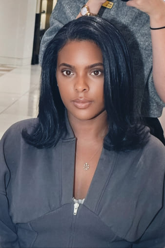 Client with a sleek silk press on type 3C hair.